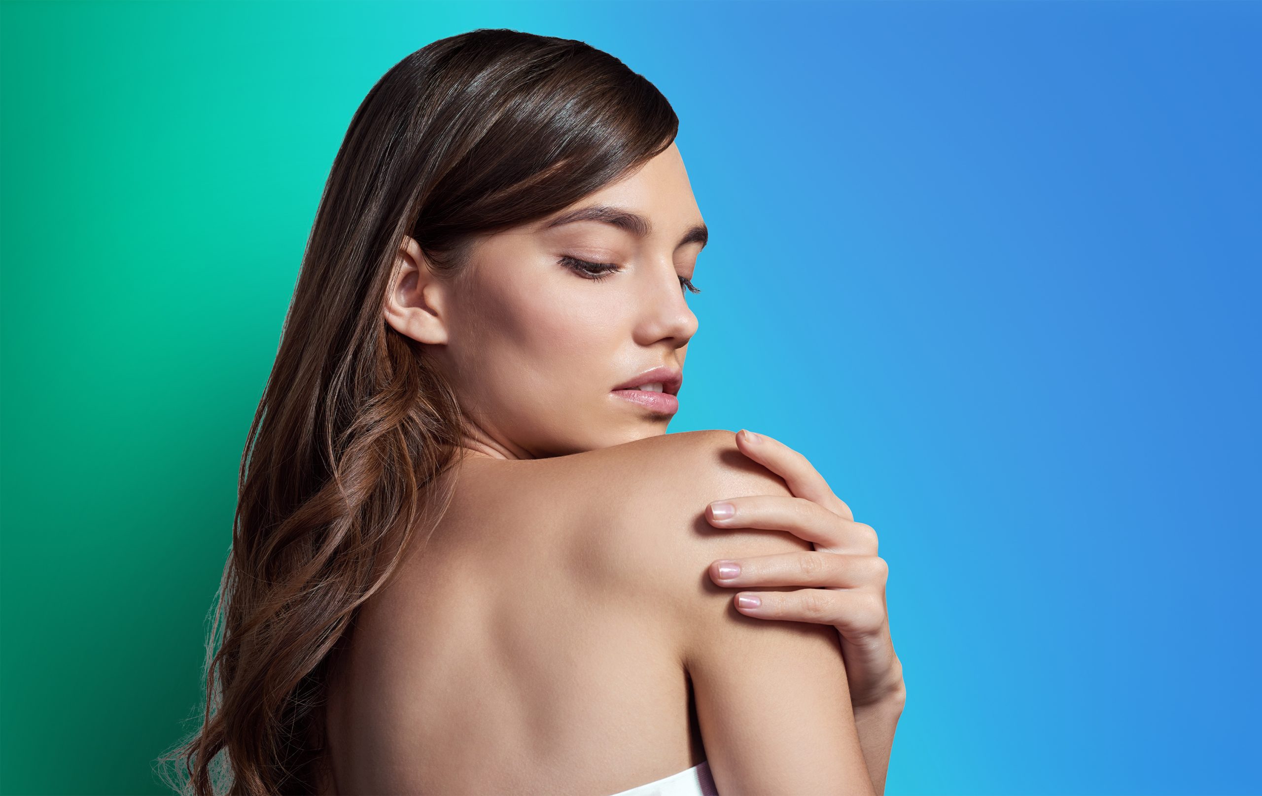 Studio shot of a beautiful young woman posing against a gray background